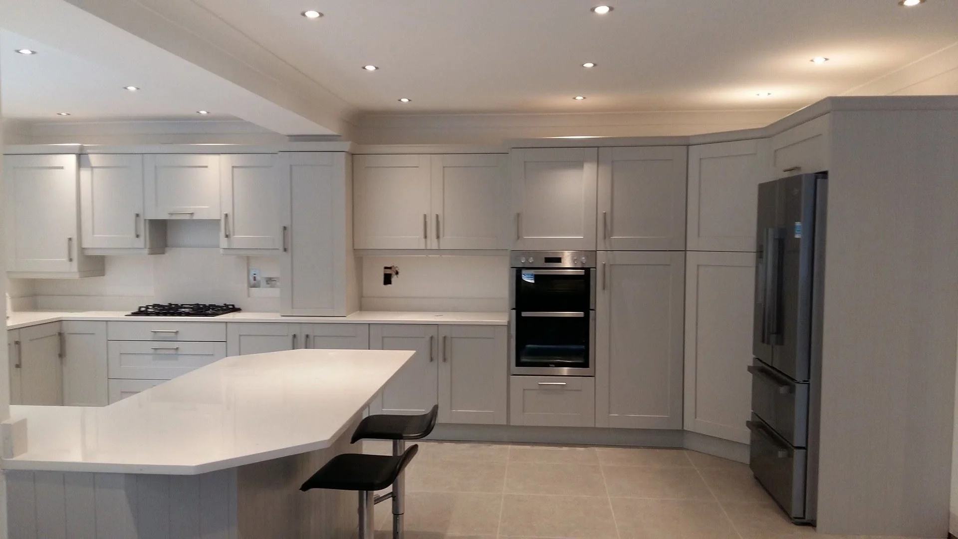 Light shaker kitchen with breakfast seating